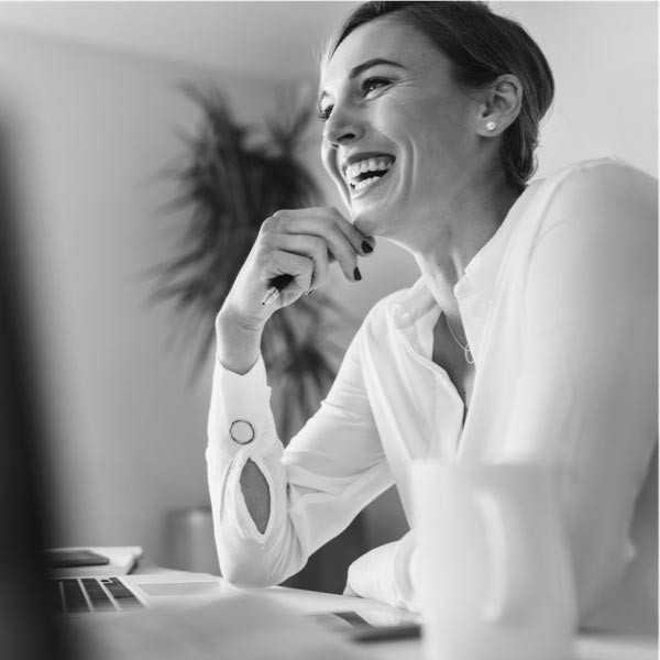 A woman laughing while in an online financial planning meeting