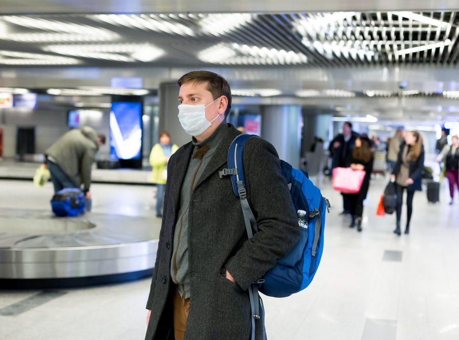 Man wearing COVID-19 mask in airport