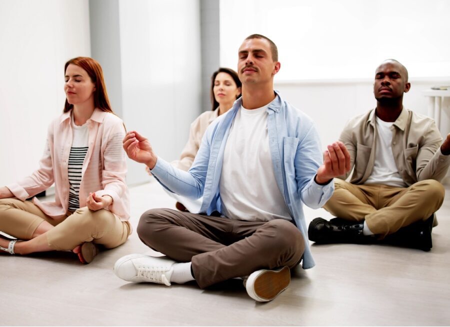 Group of employees meditate in an office