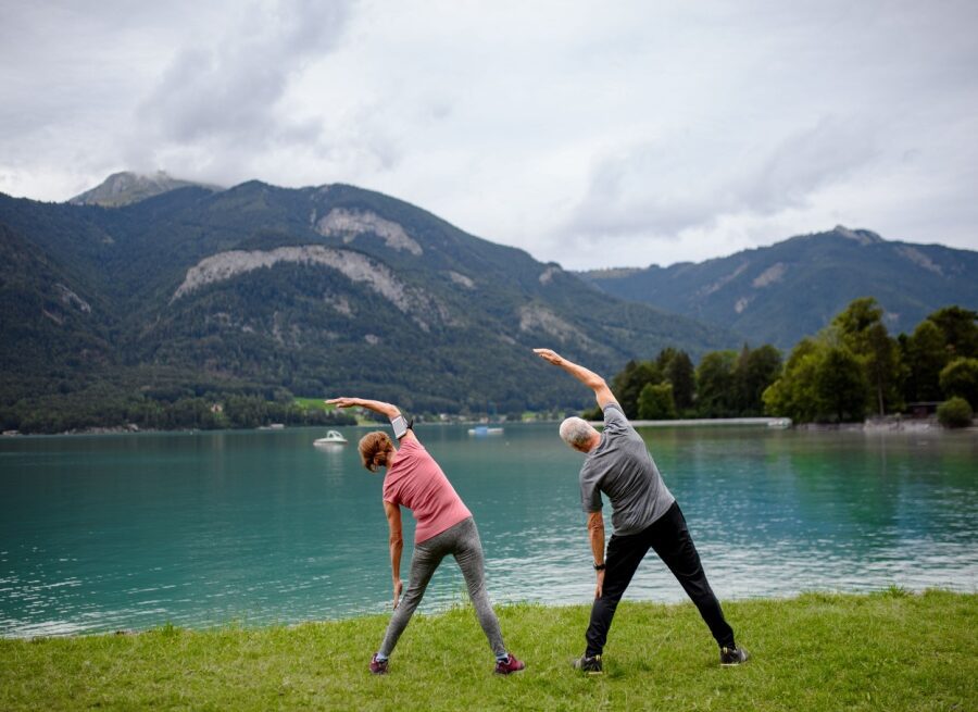 Couple doing tai chi by a lake