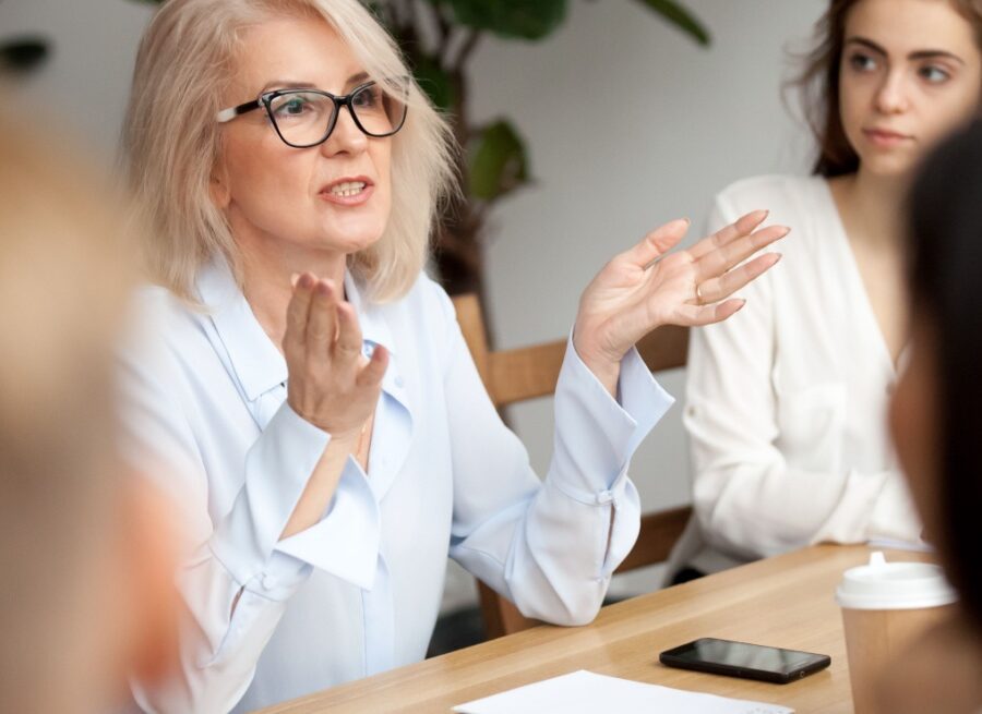 A woman talking during a work meeting.