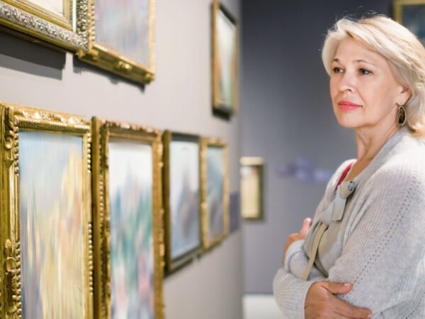 A woman looking at art in a gallery.