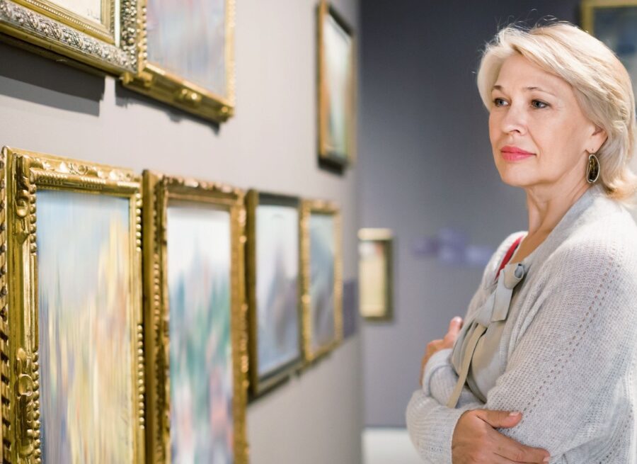 A woman looking at art in a gallery.