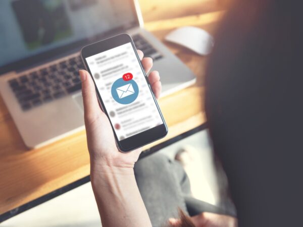 A person looking at their email on their phone.