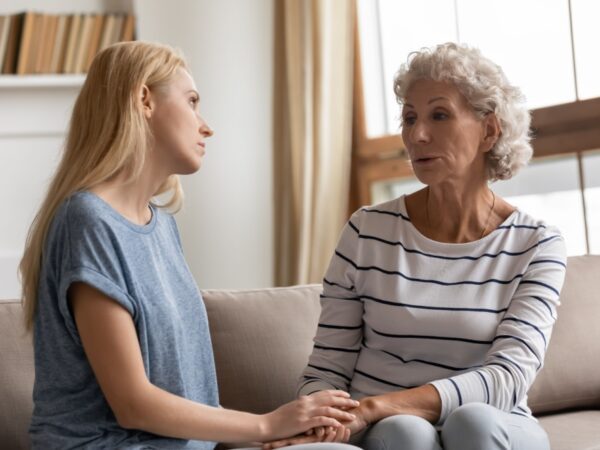 A mother and adult daughter talking.