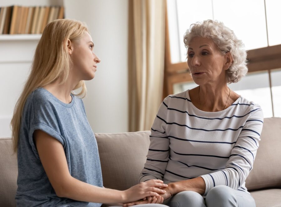A mother and adult daughter talking.