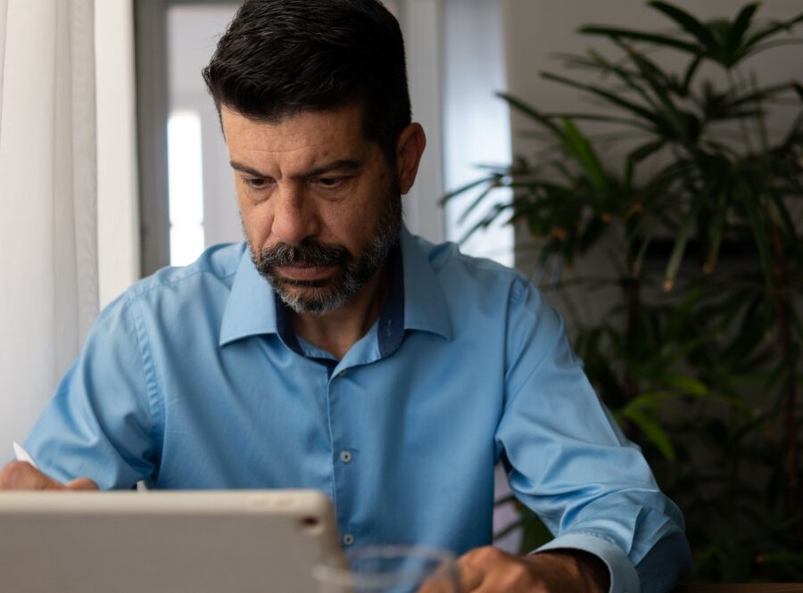 A man looking at a tablet screen.
