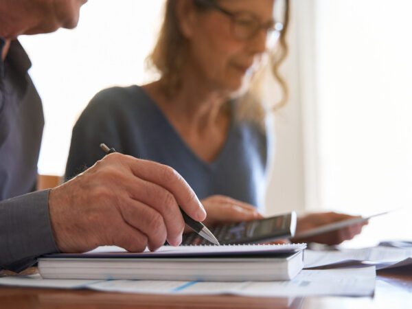 Couple looking at paperwork and using a calculator