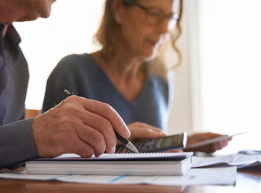 Couple looking at paperwork and using a calculator