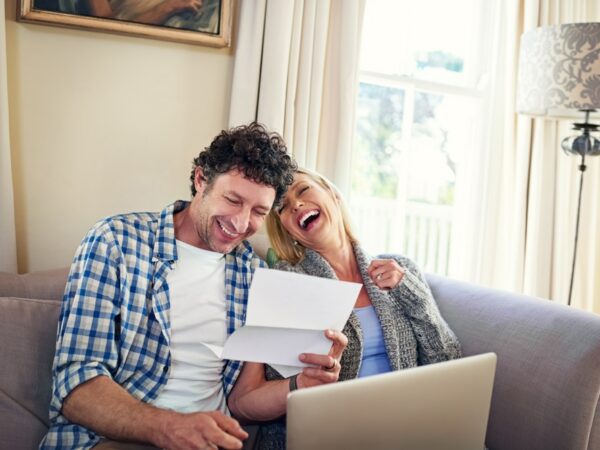 A happy couple reviewing paperwork.