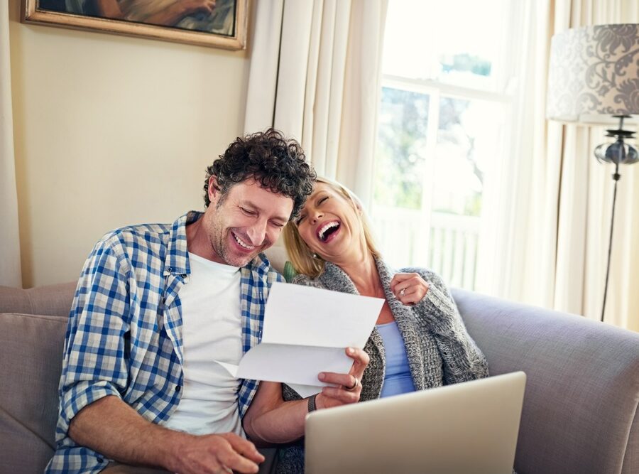 A happy couple reviewing paperwork.