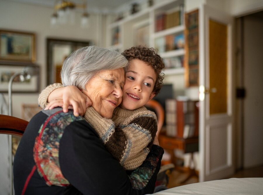 A woman hugging her grandchild.