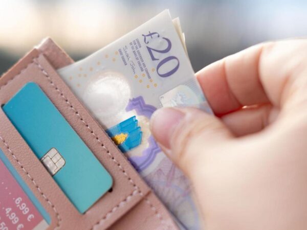 Someone taking money out of a wallet.