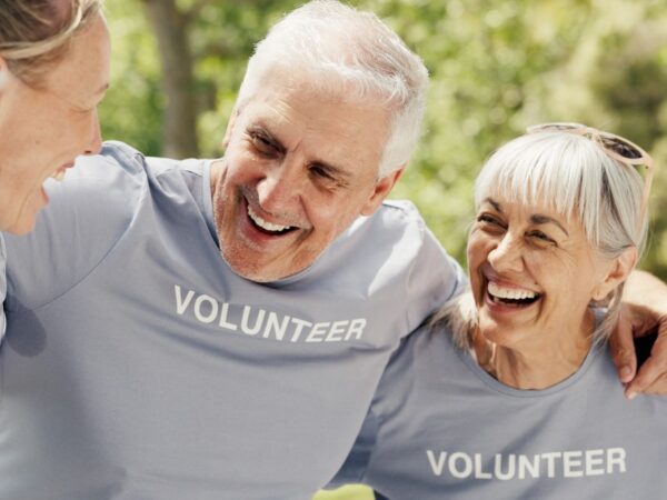 Happy senior people wearing “volunteer” t-shirts