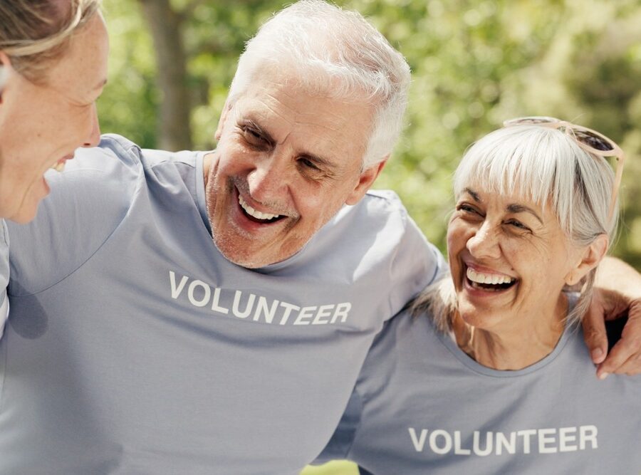 Happy senior people wearing “volunteer” t-shirts
