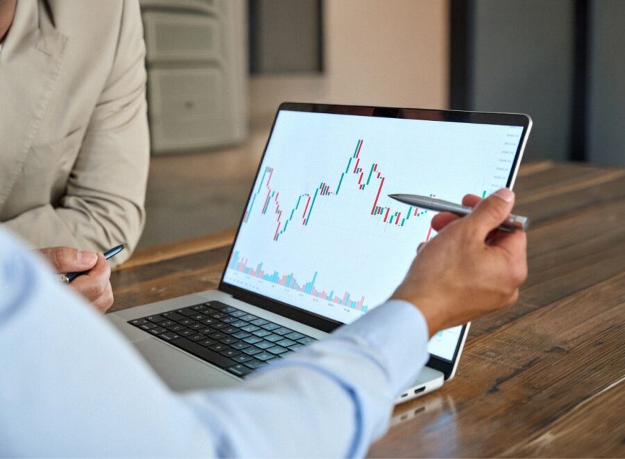 A man reviewing stock market movements on a laptop.