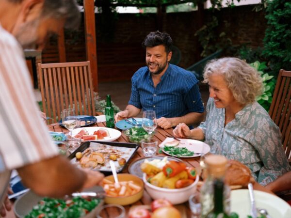 A multigenerational family eating together outdoors.