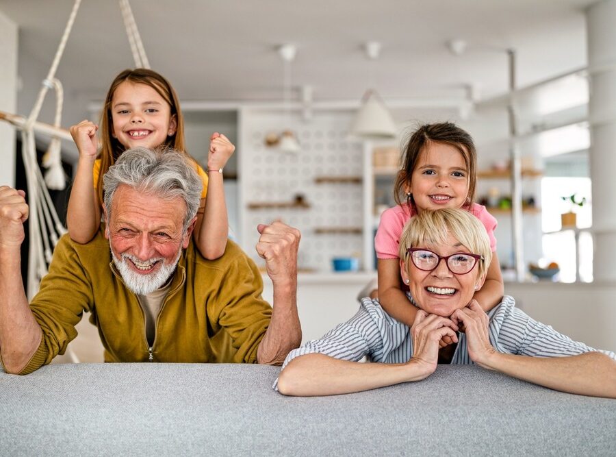 Grandchildren and grandparents having fun together in their kitchen